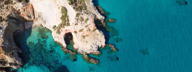 Aerial drone ultra wide photo of famous volcanic rocky beach of Tsigrado in island of Milos,...