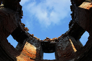 hole in the sky from inside a brick destroyed pipe with windows.