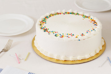vanilla birthday cake on white table
