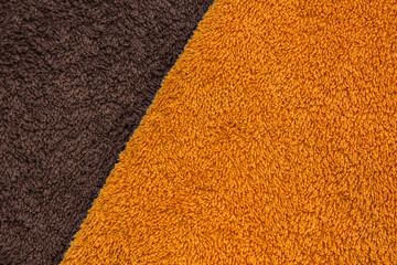 Orange and brown bath towels. Terrycloth fabric.