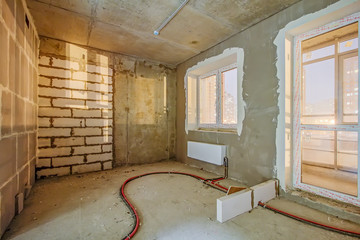 Unfinished construction empty room. Walls from lightweight aggregate concrete blocks with empty...