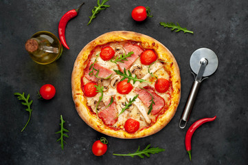  meat pizza with cheese, chicken, ham, champion mushrooms, tomatoes on a stone background