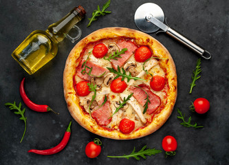  meat pizza with cheese, chicken, ham, champion mushrooms, tomatoes on a stone background