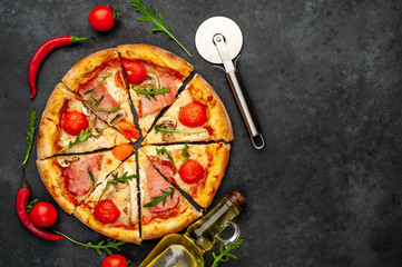 meat pizza with cheese, chicken, ham, mushrooms, tomatoes on a stone background with copy space for your text