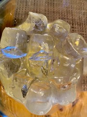 glass of whiskey with ice and ice