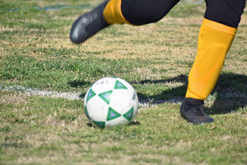 Fototapeta premium Feet Kicking a Soccer Ball