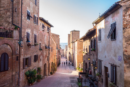 Fototapeta Certaldo, Tuscany, Italy - December 2019: View of the main cobbled street in the medieval town of Certaldo, Tuscany, Italy
