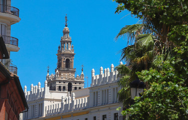 Famous tower of Giralda, Islamic architecture built by the Almohads and crowned by a Renaissance bell tower with the statue of Giraldillo at its highest point, Seville Cathedral.
