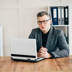 Executive manager, advisor, agent at his office workplace. Business people, employment concept. Businessman working on laptop