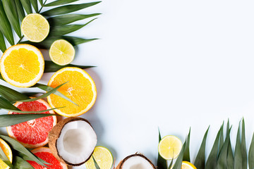 Summer vibes. Composition with exotic fruits on white background. Summertime vacation, cocktail, tropical beach. Creative fruity layout, copy space