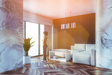 African woman in marble and gray living room