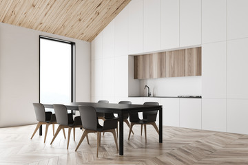White attic kitchen corner with dining table