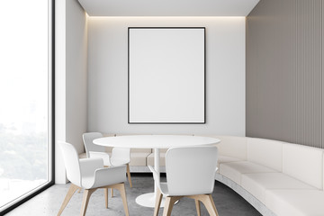 White restaurant interior with sofa and poster
