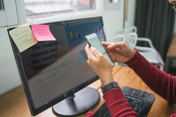 Businessman using his mobile phone at workplace.
