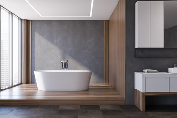 Obraz na płótnie Canvas Gray and wooden bathroom, tub and sink