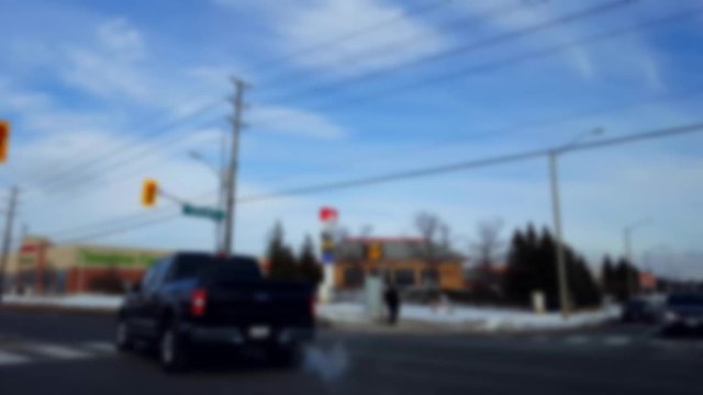 Turning Left at City Light Intersection With Blur Effect.  Turn in Urban Intersection With Traffic in Day.