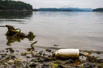 Left over marine garbage on beach small fishing buoy and rope 