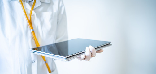doctor working on tablet medical care