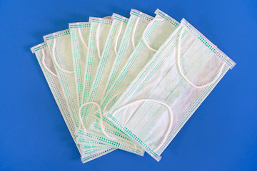 Isolated medical masks on blue background. Medical masks isolated on blue background. Coronavirus...