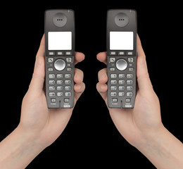 Female hands holds a phones with a white blank screen, isolated on black background