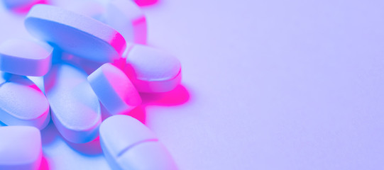 Trendy pattern made with Pharmaceutical medicine pills, tablets and capsules on bright light neon...