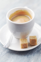 Cup of coffee on bright wooden background. Close up.