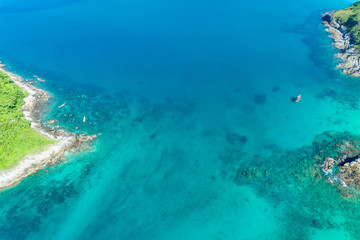 Naklejka na ściany i meble Top view landscape of tropical sea and beautiful water sea surface Aerial view drone shot, high angle view.