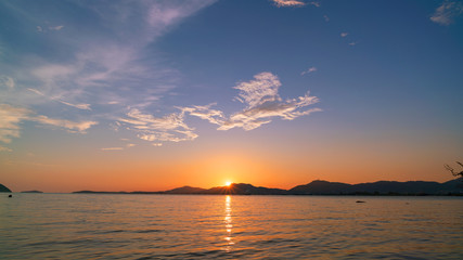 Beautiful light sunset over sea dramatic sky.