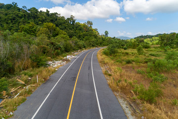 Fototapeta na wymiar Asphalt road curve with yellow line on road image by drone camera high angle view.