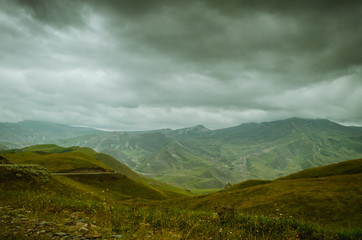 Fototapeta premium Cycling mountain road. Misty mountain road in high mountains.. Cloudy sky with mountain road