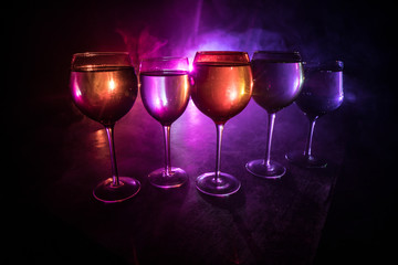 Goblet of white wine on wooden table on wooden wall background