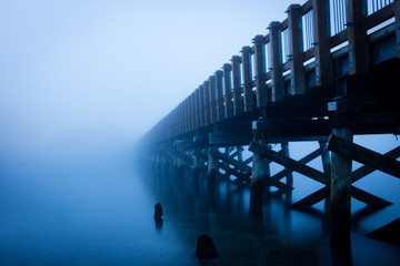 Taylor Dock foot bridge in Bellingham, Washington, disappears into the winter fog along the Salish...