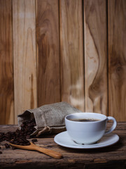 Fototapeta na wymiar Coffee in a white cup and seeds Coffee on a wooden table