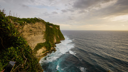 A view of Idian Ocean from Bali, Indonesia. Beautiful blue ocean water and a hanging cliff by the sea