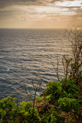 A view of Idian Ocean from Bali, Indonesia. Beautiful blue ocean water and a hanging cliff by the sea
