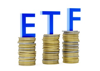 ETF - exchange traded funds - acronym on stacks of coins over white background