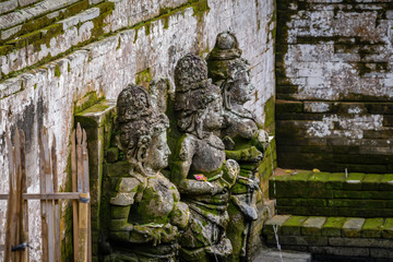 Balinese sculptures and traditional architectural details in a temple near Ubud, Bali, Indonesia