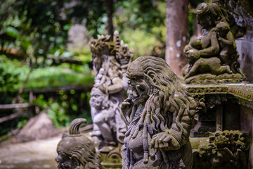 Balinese sculptures and traditional architectural details in a temple near Ubud, Bali, Indonesia