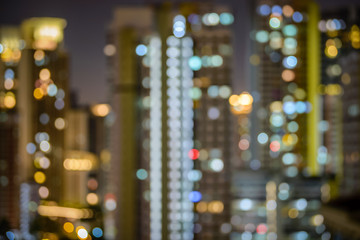 Blurry city scape of public housing in central Singapore, light bokeh during blue hour