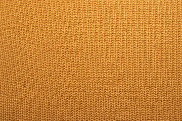 Mustard knitted background, fragment of knitwear