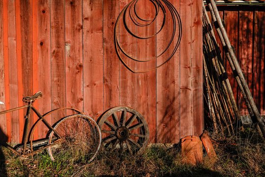 Stockholm, Sweden A picturesque red barn wall with old farm tools and a bicycle.