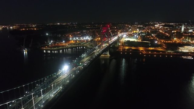Bridge across river in modern big Philadelphia city downtown in night light illumination in amazing 4k aerial cityscape