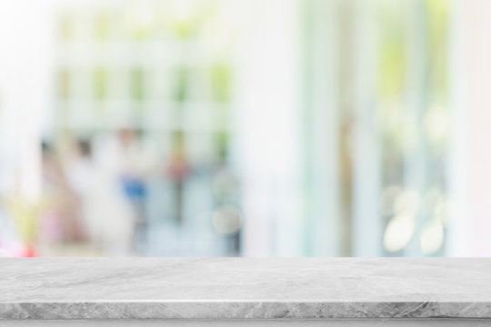 Empty White Stone Marble Table Top And Blurred Of Interior Restaurant With Window View Green From Tree Garden Background Background - Can Used For Display Or Montage Your Products.