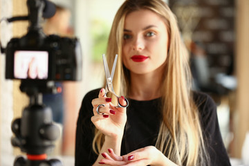 Blonde Woman Blogger Holding Metallic Scissors. Hairdresser Recording Modeling Instrument for...