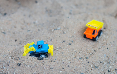 children toy truck on sand. concept of transportation and  building materials