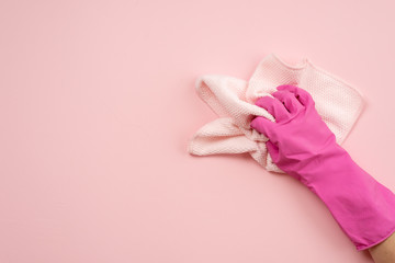 Hand in latex gloves and cloth on a horizontal surface