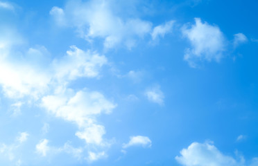 ิblue sky against white floating clouds background