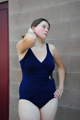 Fototapeta na wymiar Female beauty in a blue swimsuit outside.