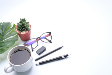 office desk. Workspace,cactus, green leaf,eye glasses,pen, and coffee cup on white background