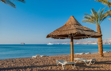 Eilat is idyllic vacation and tourist resort city with nice beaches for vacation and resting. Image is for the use as background or wallpaper. Design of tourism for summer vacation or holiday concept